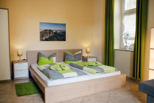 a bedroom with a bed with two pillows at Haus Wettin in Bad Schandau