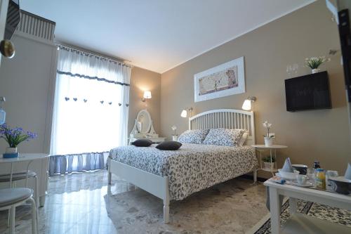 a bedroom with a bed and a television in it at Dimora Pascali Holiday - " Home & Relax " in Polignano a Mare