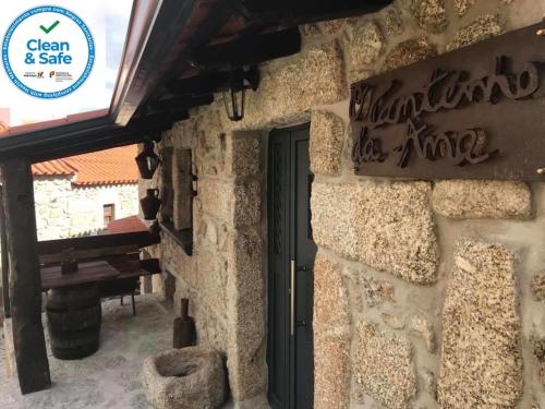 a building with a door and a sign on it at O Cantinho da Ana in Sortelha