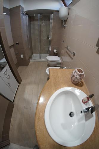 a bathroom with a sink and a shower and a toilet at Aiello house in Pompei