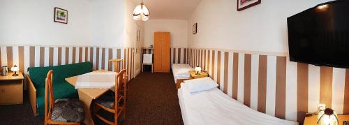 a room with three beds and a flat screen tv at Ogrodowe zacisze in Jastrzębia Góra