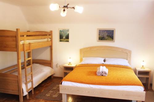 a bedroom with a bunk bed with two shoes on it at Homestead Zatrnik near Bled in Bled