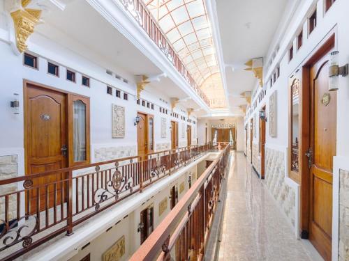 an empty corridor of a building with wooden balconies at Collection O 3468 Ndalem Gusti Ayu in Yogyakarta