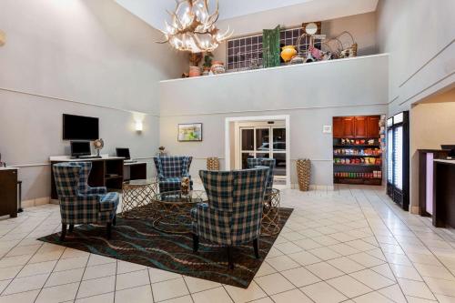 a lobby with chairs and a desk and a television at La Quinta by Wyndham Kerrville in Kerrville