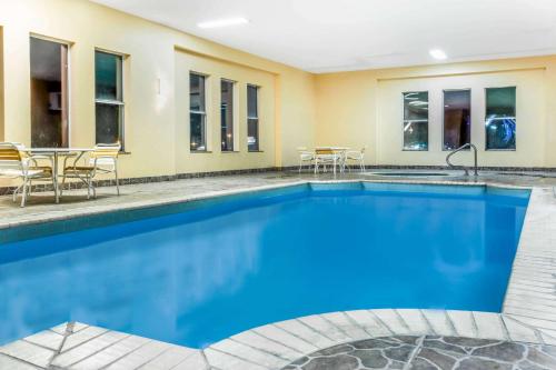 a pool in a hotel room with chairs and a table at La Quinta by Wyndham Kerrville in Kerrville