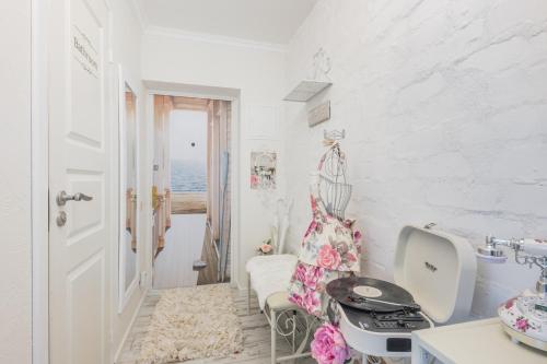 a white room with a sink and a table at Vintage Lounge studio by the sea in Liepaja in Liepāja