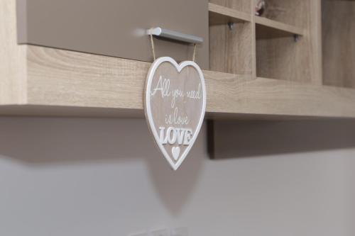 a heart shaped sign hanging from a drawer at Robert 's apartament in Ploieşti