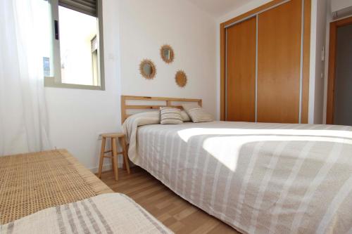 a bedroom with two beds and a window at Can Lou-Casa con Caracter en Cullera in Faro de Cullera