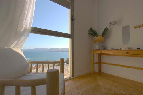 a room with a large window with a view of the ocean at Can Lou-Casa con Caracter en Cullera in Faro de Cullera