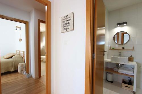 a bathroom with a sink and a mirror at Can Lou-Casa con Caracter en Cullera in Faro de Cullera