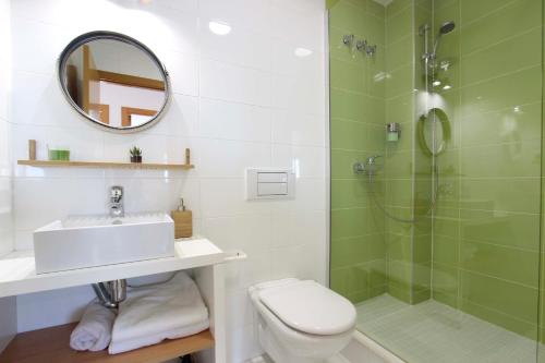 a bathroom with a shower and a sink and a toilet at Can Lou-Casa con Caracter en Cullera in Faro de Cullera