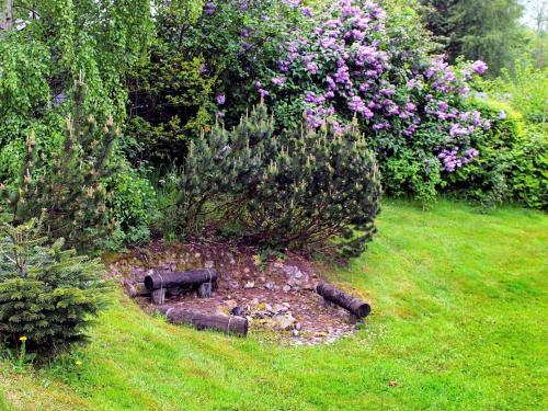 a garden with a bench in the grass at 8 person holiday home in Aabenraa in Loddenhøj