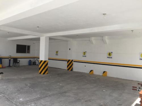 a large room with a white ceiling and yellow and black stripes at Hotel Seny in Ambato