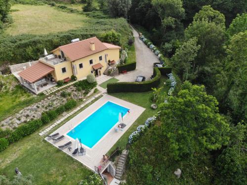 an aerial view of a house with a swimming pool at CASA DO SORRO in Ponte de Lima