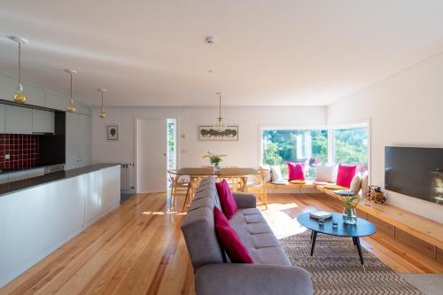 a living room with a couch and a table at Encosta do Sobreiro - Serra da Estrela in Fornos de Algodres
