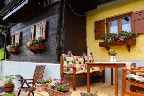 a patio with a table and chairs and a house at Ferienhaus Aurelia in Kitzeck im Sausal