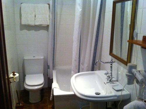 a bathroom with a sink and a toilet and a shower at Casa das Augas Santas in Aguas Santas