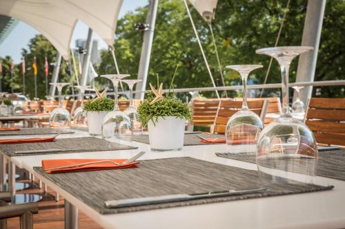 a table with glasses and potted plants on it at Quality Hotel Brno Exhibition Centre in Brno