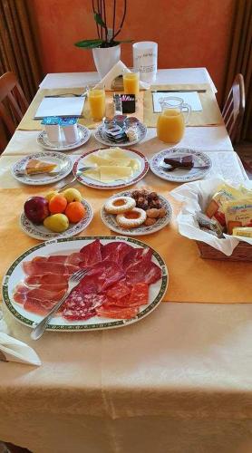 a table with many plates of food on it at Apartment Lake Maggiore - Gelsomino in Maccagno Inferiore