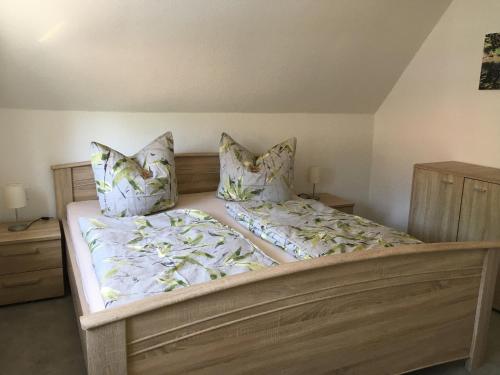 a bedroom with a large bed with pillows at Ferienwohnung Möckel in Struppen