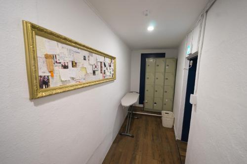 a hallway with a toilet and a picture on the wall at Beewon Guesthouse in Seoul