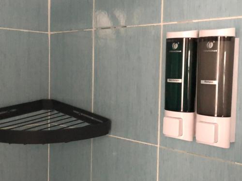 a corner of a tiled wall with a coffee maker at La Terrazza Di Arturo Guest House in Turin