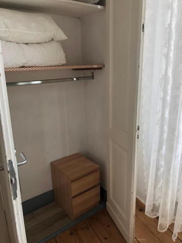 a small room with a bunk bed and a wooden drawer at La Terrazza Di Arturo Guest House in Turin