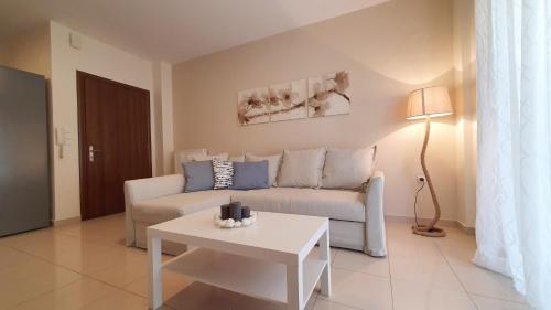 a living room with a couch and a table at Sweet Puzzle in Preveza