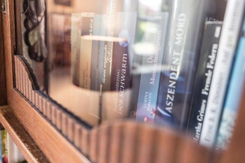 a book shelf filled with lots of books at Fachwerk-Treppenspeicher, Ruhe auf dem Land, Haustiere willkommen, Leihfahrräder, 24-7 check in in Kirchlinteln