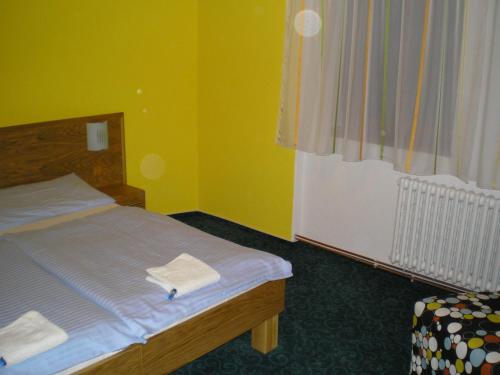 a bedroom with a bed with two towels on it at Pension Duel in Ústí nad Labem