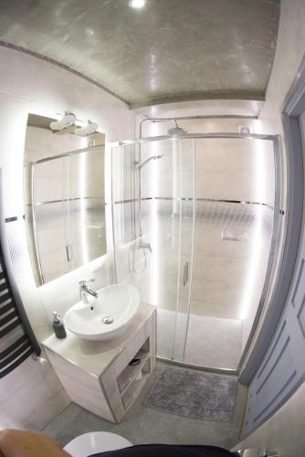 a small bathroom with a sink and a shower at Chata Wuja Toma in Szczyrk