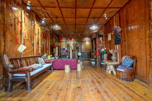 a room with wooden walls and wooden floors and benches at Forest Glass inn in Zhangjiajie