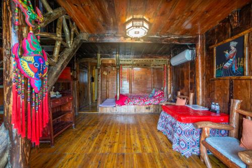 a bedroom with a bed in a room with wooden walls at Forest Glass inn in Zhangjiajie