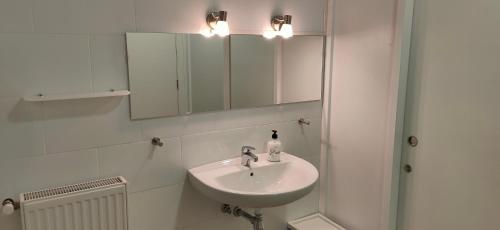 a bathroom with a sink and a mirror at Albergue Valderrobres Auto check-in in Valderrobres