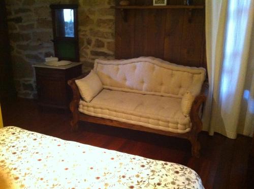 a white couch in a room with a bed at Casa das Augas Santas in Aguas Santas