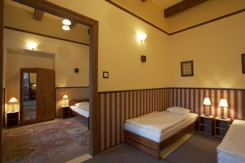 a bedroom with two beds and a large mirror at Globtroter Guest House in Krakow