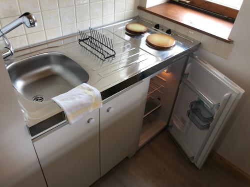 a small kitchen with a sink and a refrigerator at Loft mon Soleil in Le Hohwald