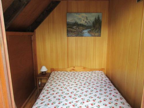 a bedroom with a bed and a painting on the wall at chalet ST PIERRE DELS FORCATS in Saint-Pierre-dels-Forcats