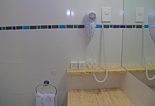a bathroom with a sink and a shower stall at Hotel America in Montevideo