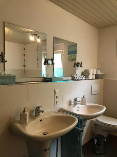 a bathroom with two sinks and a toilet at Ferienwohnung Petra in Rust