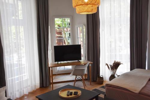 a living room with a desk with a computer on it at DOM APARTS in Cologne