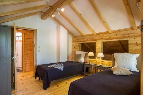 a bedroom with two beds and a desk with a lamp at Garmen Hills Guest Houses in Garmen
