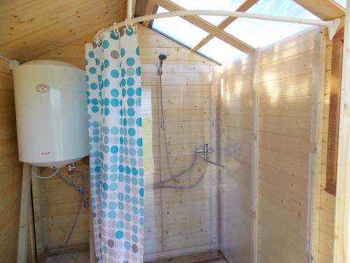 a bathroom with a shower in a wooden wall at Kastani Camping in Haapsalu