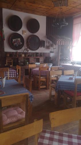 a room with tables and chairs and plates on the wall at Etno Konak Angela in Kalna