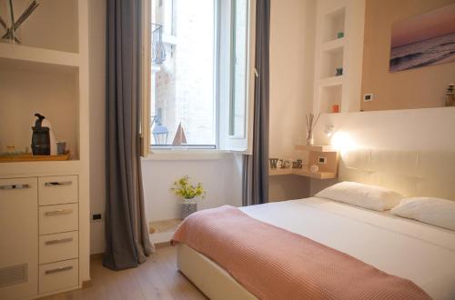 Un dormitorio con una cama grande y una ventana. en Terra d'Acqua, en Monopoli