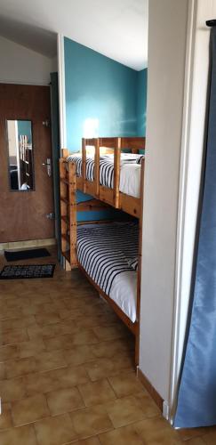 a hallway with three bunk beds in a room at Studio des Saintes in Saintes-Maries-de-la-Mer