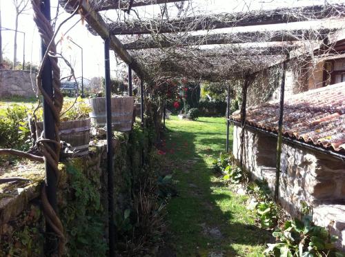 a garden with a pergola over a yard at Casa das Augas Santas in Aguas Santas