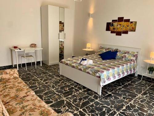a bedroom with a bed and a table at Casa Delizia in Vittoria