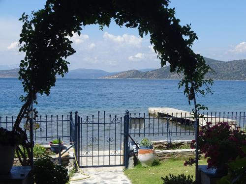 a gate leading to a large body of water at Blue Dreams in Almiropótamos