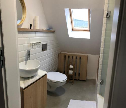 a bathroom with a toilet and a sink and a window at CASA SMIDA JAZZ in Smida